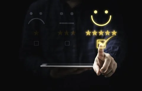Customer holding tablet and touching to tick sign on virtual smiley face fo.. Stock Photos