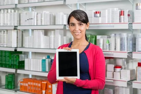 Customer Holding Tablet Computer With Blank Screen In Pharmacy Stock Photos