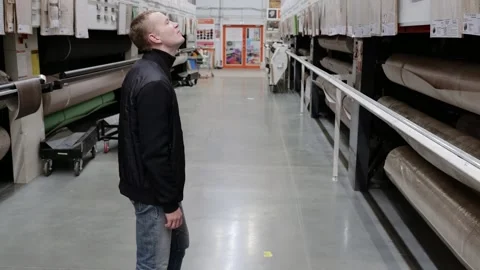 Customer is looking up at the ceiling while standing in a hardware store Stock Footage 306502451