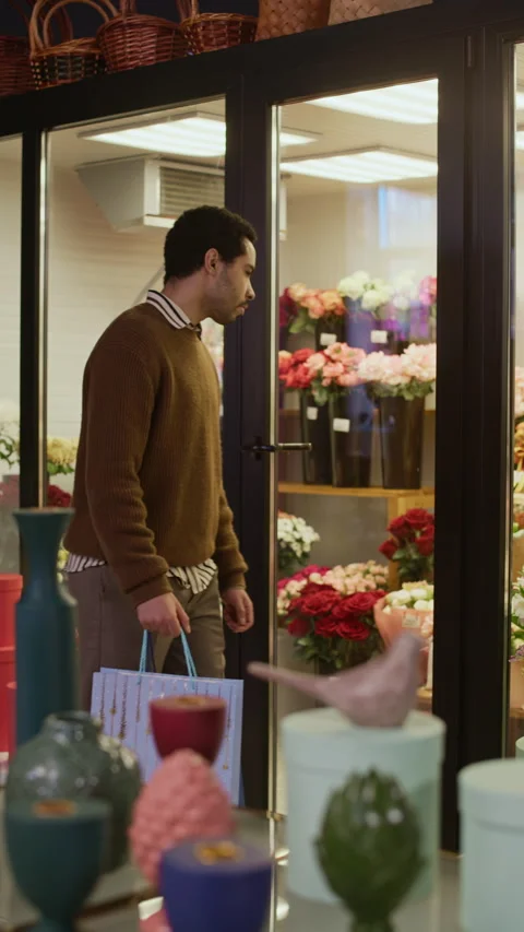 Customer Looking at Flower Bouquets Visiting Gift Shop Stock Footage 321327387