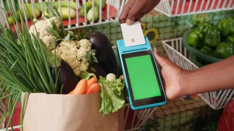 Customer Makes Cashless Card Payment via POS Terminal for Produce Green Screen Video stock 345838851
