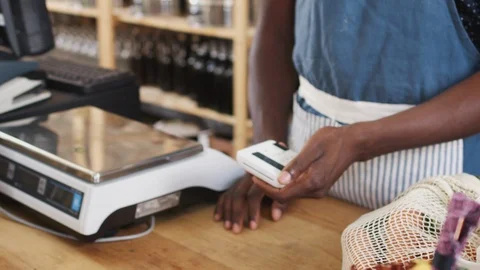 Customer Making Contactless Payment For Shopping At Checkout Of Grocery Store Video stock 111931380