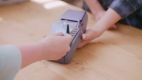 Customer making contactless payment through credit card in store Stock Footage 79659533