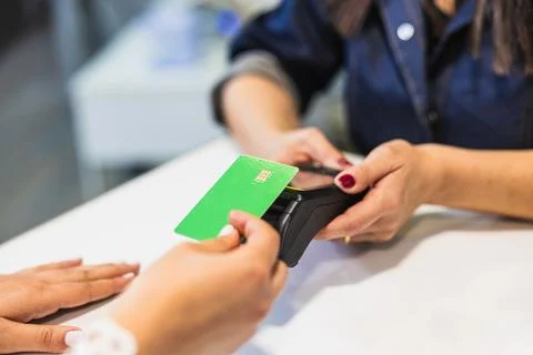 Customer making contactless payment using green credit card Fotos Stock