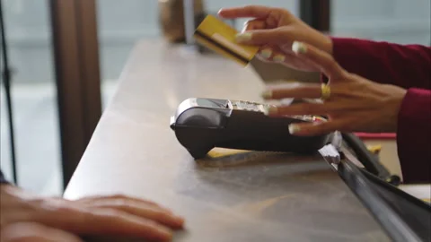 Customer making payment at hotel reception using credit card terminal Stock Footage 316367253