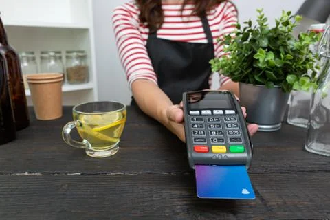 Customer making wireless or contactless payment using credit card Stock Photos