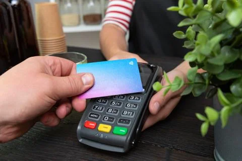 Customer making wireless or contactless payment using credit card Stock Photos