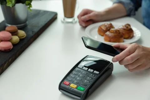 Customer making wireless or contactless payment using smartphone, nfc payment Stock Photos