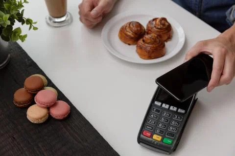 Customer making wireless or contactless payment using smartphone, nfc payment Stock Photos