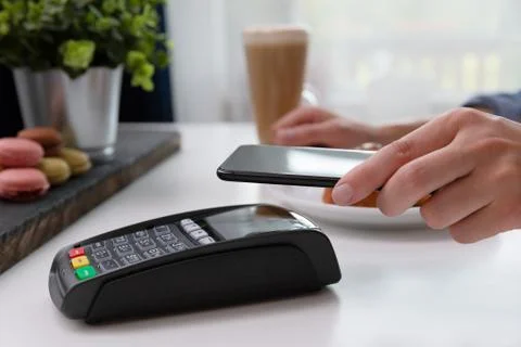 Customer making wireless or contactless payment using smartphone, nfc payment Stock Photos