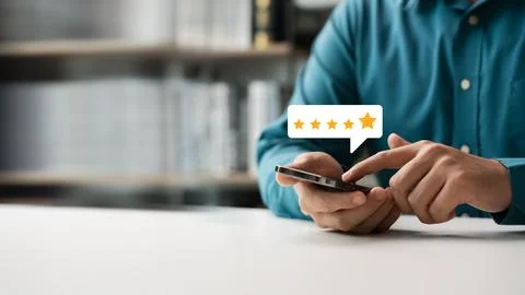 Customer man using smartphone express satisfaction Golden five star level E.. Stock Photos