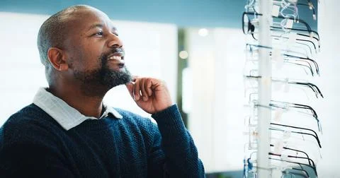 Customer, optometry or black man thinking with glasses in store for frame o.. Stock Photos