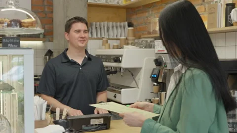 Customer Ordering Coffee While Reading Menu At Cozy Modern Cafe Counter Video stock 313847413