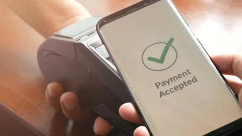 Customer paying bill through smartphone using NFC technology at point of sale Video stock 133173097