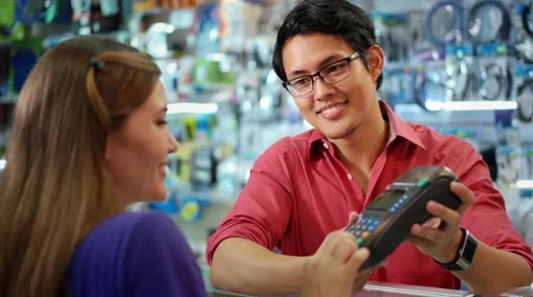 Customer Paying With Credit Card In Chinese Computer Shop Stock Footage