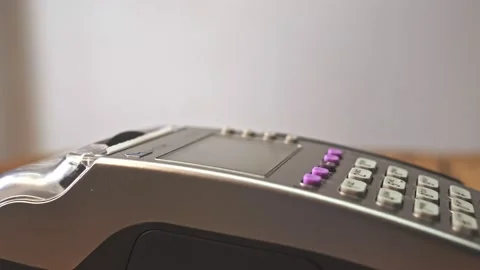 Customer paying with NFC technology by mobile phone on POS terminal Stock Footage 131299508