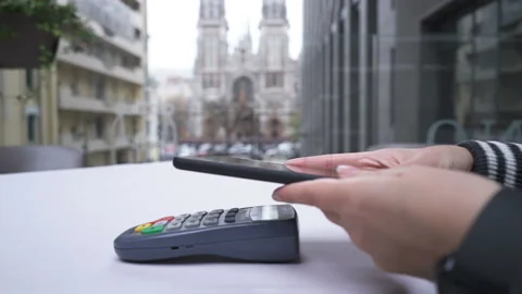Customer paying with NFC technology by phone contactless on terminal Video stock 144621245