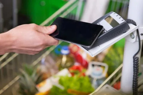Customer paying with NFC technology Stock Photos