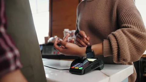 Customer paying with NFC technology by smart watch contactless on terminal in Stock Footage 139767457