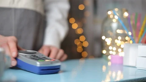Customer is paying with smartphone in shop using NFC technology.  Stock Footage 120571957