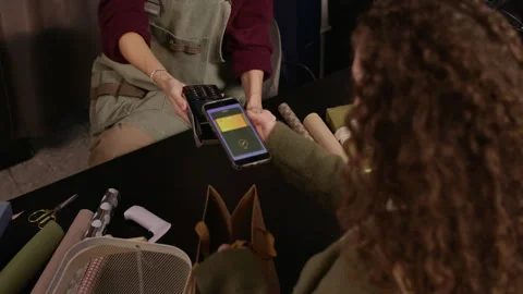 Customer Paying by Smartphone on Terminal in Gift Store Stock Footage 321341489