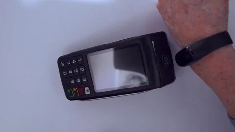 Customer paying with a smartwatch using nfc technology at a pos terminal, isolat Stock Footage 331850689