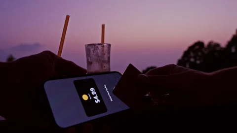 Customer Paying With Tap To Pay on IPhone Using Contactless Bank Card Near Sunse Stock Footage 330552124