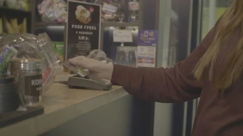 Customer paying using credit card contactless payment service spending money at Stock Footage 136727022