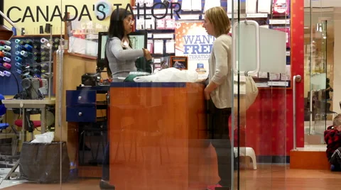 Customer paying for work after tailor showing her paint Stock Footage 68567859