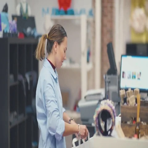 The customer pays for the purchase in the store. Friendly staff Stock Footage 69478971
