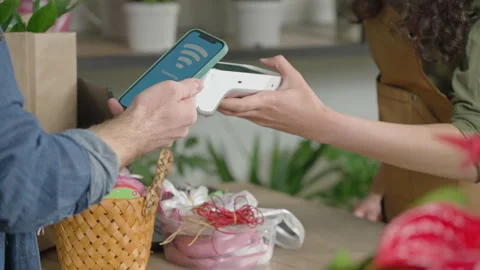 The customer pays for the purchase using NFC technology using a phone Stock Footage 151624680