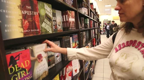 Customer picking a book from the shelve Stock Footage 50010027