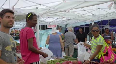 Customer picking fresh veggies on Lincoln Rd, Miami Beach Stock Footage 65780461