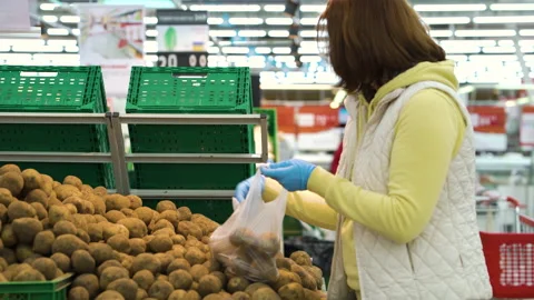 Customer picking potatoes at grocery store during pandemic Stock Footage 130305693