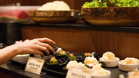 Customer Picking Side Dishes at a Japanese Food Buffet Restaurant Stock Footage 341542729