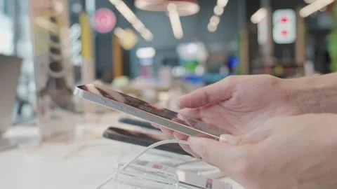 Customer picking smartphone in electronics store Stock Footage 283759730