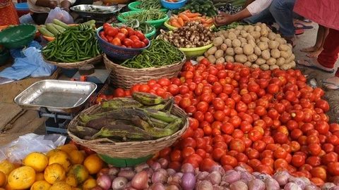 A-customer-picks-vegetables-from-a-streeet-vendor-India Stock Footage 92052773
