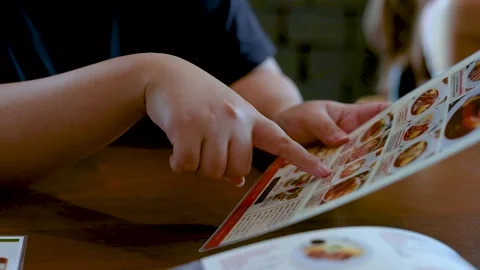 Customer Pointing at Menu While Choosing Food in Restaurant Stock Footage 321325433