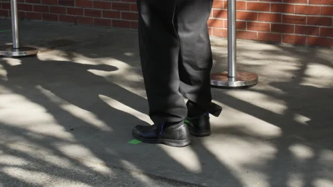A customer practicing social distancing while getting let into a grocery store Video stock 131003381