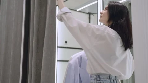 Customer Pulls Curtain in Retail Store Fitting Room Stock-Footage 311873296