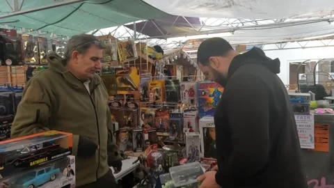 Customer Purchasing Gears of War Figure at a Toy Fair. Stock Footage 300738776