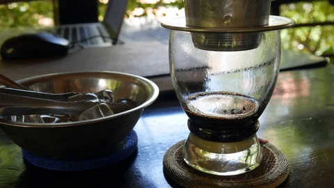 Customer puts ice in coffee with milk before drinking. Using a Vietnamese Video stock 113801686