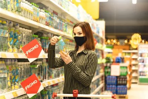 Customer read composition of product in hypermarket. Shopper in store Stock Photos