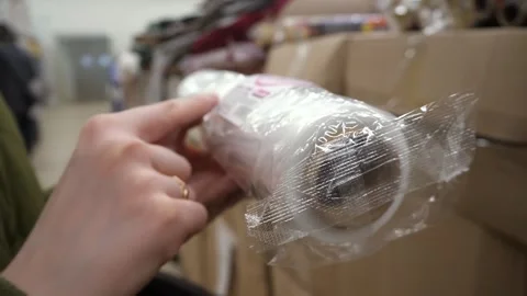 The customer reads the characteristics, description of cling film in the store 스톡 동영상 269409719