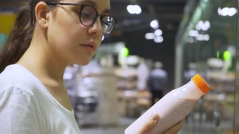 The customer reads the information on the bottle label before buying. Stock Footage 252260790