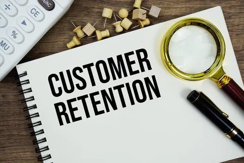 Customer Retention text written on notepad with calculator and magnifying g.. Stock Photos