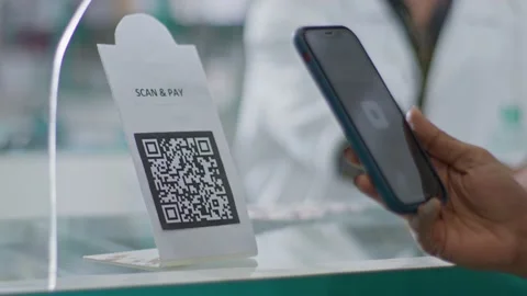 Customer scanning a barcode to pay e-money online in a general or grocery store Stock Footage 233786074