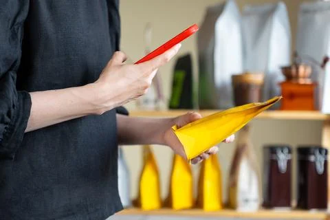 Customer Scanning Coffee Package With Smartphone Stock Photos