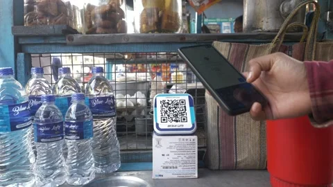 Customer scanning Paytm QR codes for fast UPI payment at Indian street vendor Stock Footage 295909001