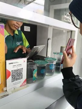 Customer scans QR code at beverage counter Stock-Fotos